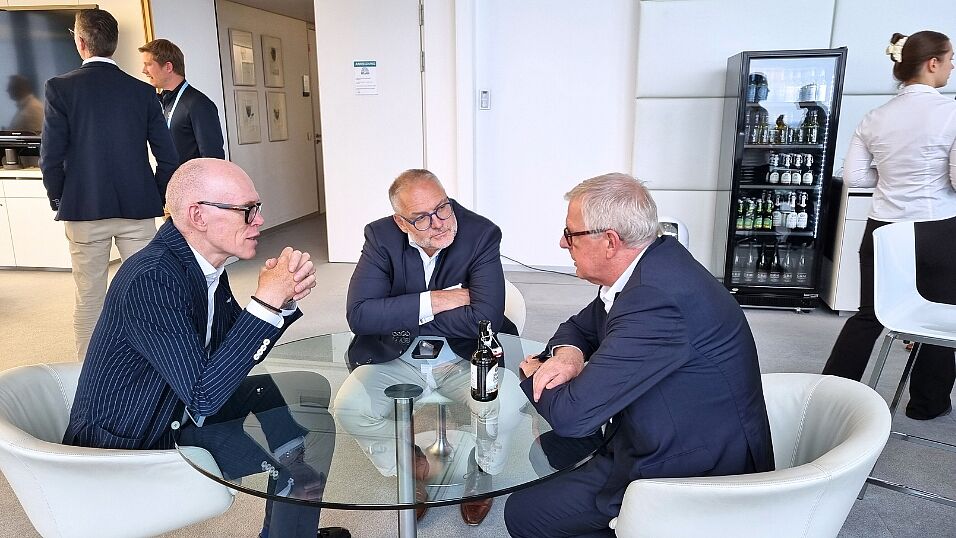 Three attendees discussing topics at a table during the evening event at The Automotive Battery – Key Technology for Electric Vehicles 9th - 10th July 2025