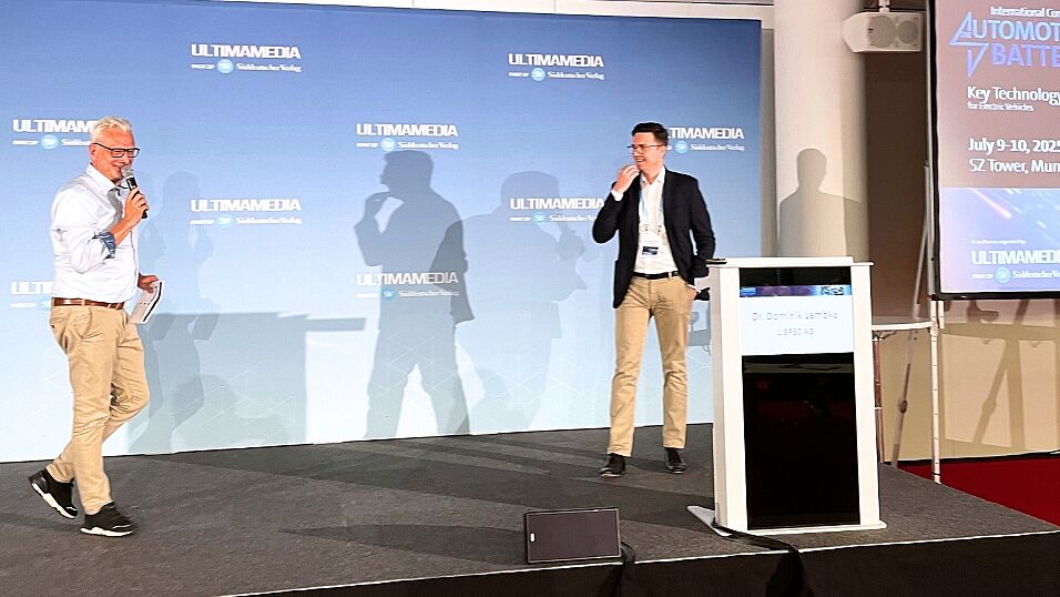 Chairman Peter Gresch and Speaker Dr. Dominik Lembke, Chief Business Development Officer, LIBREC AG joking on stage at The Automotive Battery – Key Technology for Electric Vehicles 9th - 10th July 2025
